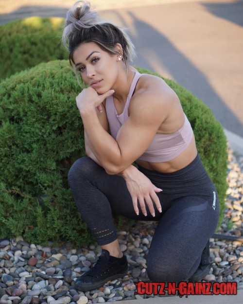 Bodybuilderin Cass Martin zeigt Muskeln in der Denkerpose.